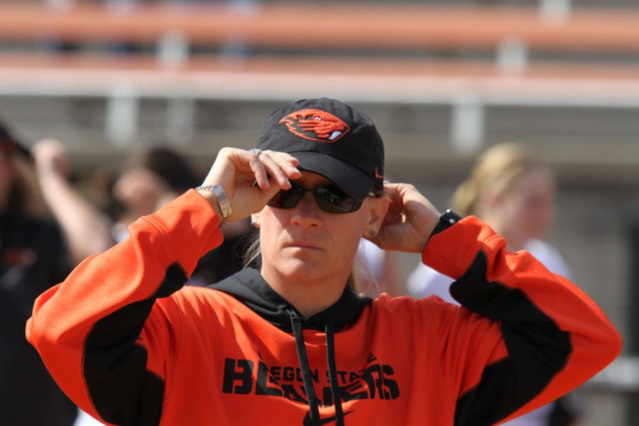 Oregon State University women’s softball head coach Laura Berg adjust her hat during a game against the Arizona Wildcats April 4 in Corvallis.