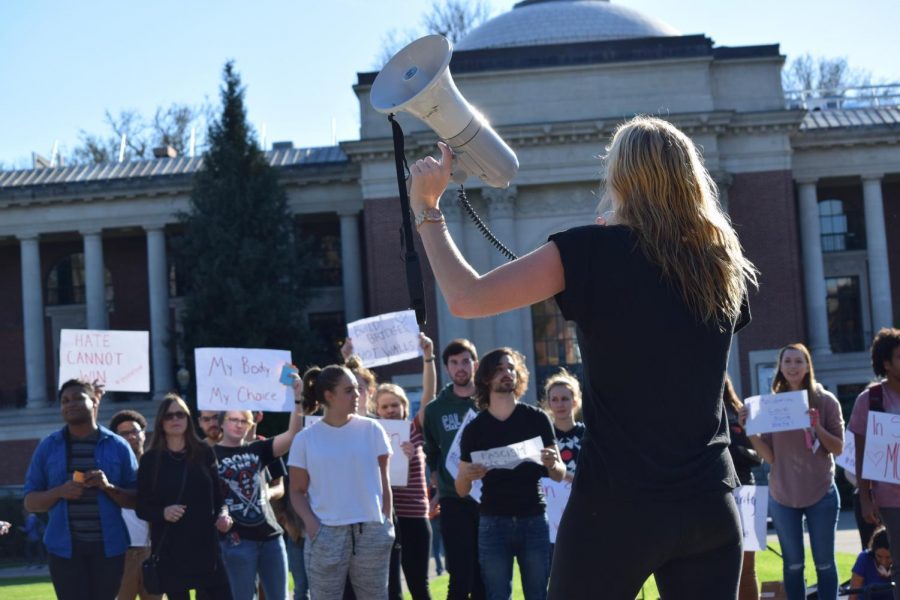 Tabitha Pitzer, an OSU junior, leads protesters in a chant in the Memorial Union quad Nov. 9. Pitzer, along with many others, wanted to spread messages of unity, peace and community following the presidential election.