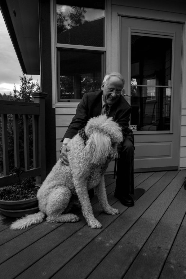 OSU+President+Emeritus+Ed+Ray+sitting+on+his+porch+with+his+dog+Gus+in+2016.