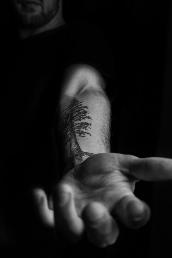 Jacob Eldred Bucher got a Douglas fir, his family tree, tattooed onto his forearm.