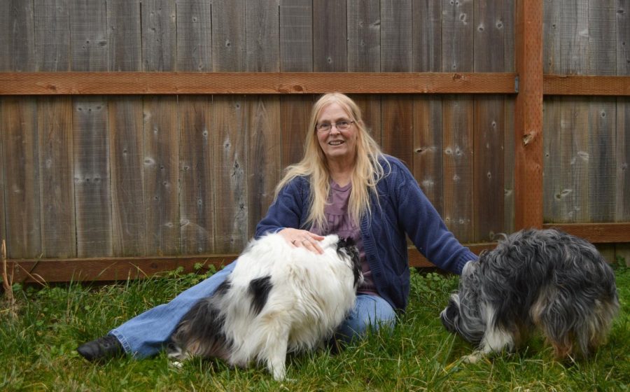Dodi Reesman sitting with her dogs Capone (LEFT) and Dillinger (RIGHT). The house Reesman lives in has been sold and she is being evicted. Her students are trying to help.