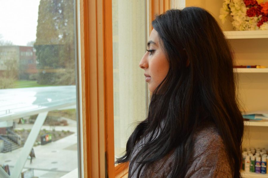 Roaa Albish observes the OSU campus through a window in the ECC. Being Muslim, Albish has felt the effects of Islamophobia.