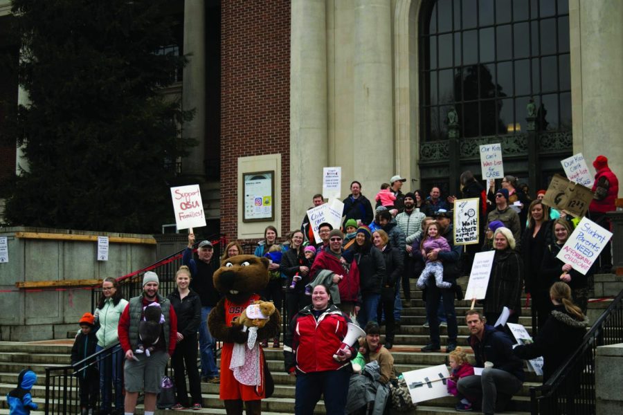 Community members and Oregon State University students gather on the steps of the Memorial Union during the Beavers Have Babies, Dam It! rally. The event worked to convey a sense of urgency surrounding the lack of affordable and accessible childcare. 