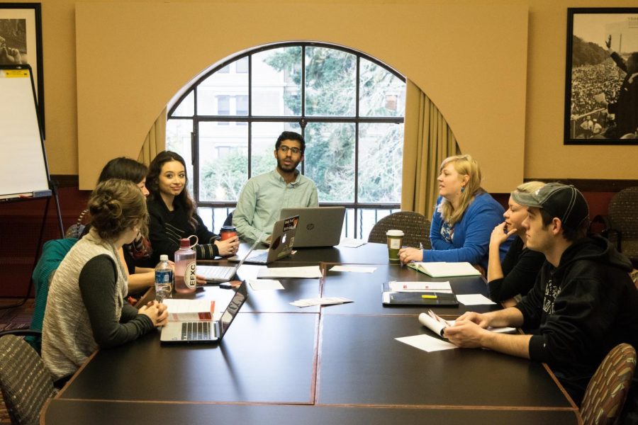 Rishi Seshadri (center) leads a SHAB meeting early Tuesday morning in the Memorial Union. He and his fellow board members constitute the first group which reviews Student Health Services budgets. 