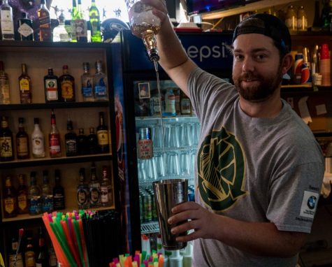 Bartender Austin Hogue pours a drink at The Dam, which took second place in the best of live music venue category. 