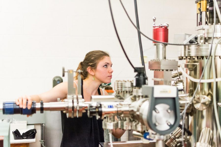 Bethany Matthews, a physics graduate student at Oregon State University, checking on a vacuum chamber used to create thin film material. Matthews recently won a U.S. Department of Energy Office of Science Graduate Student Research Award, and the Ben and Elaine Whiteley Endowment for Materials Research Fellowship.