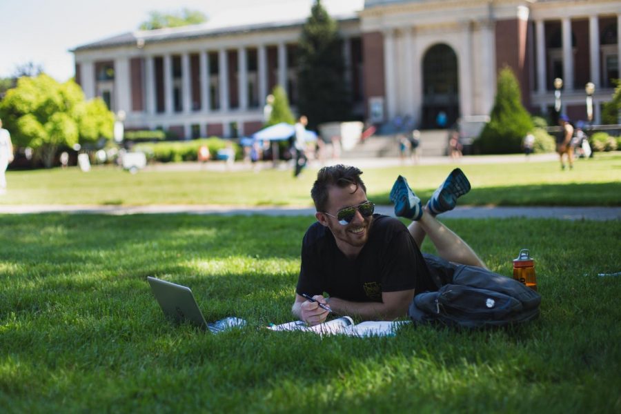 Second-year ecological engineering student Dan Hofmann prepares for summer courses outside the Memorial Union. 