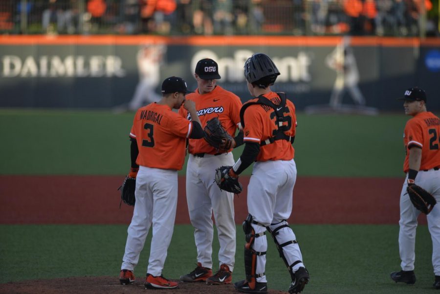 OSU players Nick Madrigal, Drew Masmussen and Adley Rutschman meet at the mound to dicuss strategy after a pitch.
