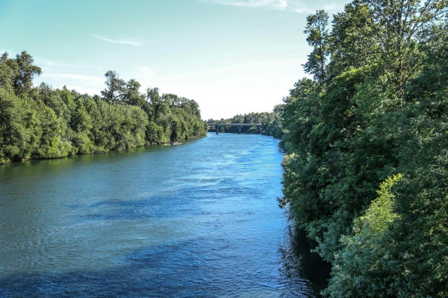 The Willamette River flowing under the bridge connecting Oregon Route 34 and downtown Corvallis. The Willamette is a popular place for students to float when the temperatures get high during the summer.