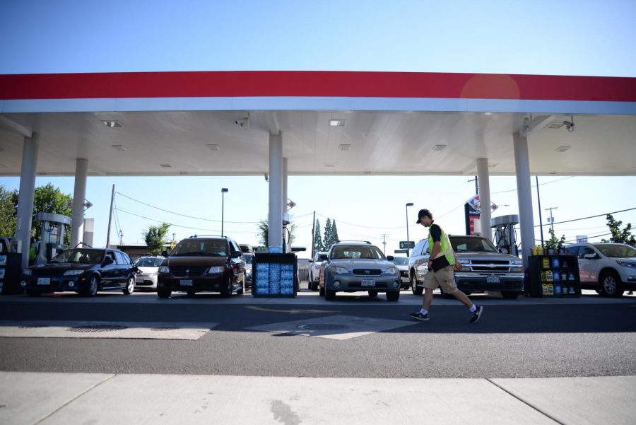 A Fred Meyer gas station attendant works to keep up with motorists on Aug. 18, 2017. Oregons decades-long ban on self-serve gas was lifted by the passage of House Bill 2426.