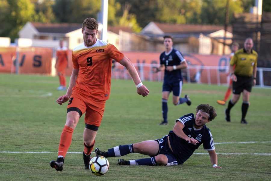 OSUs Timmy Mueller dribbles past a Trinity Western defender during a game on Aug. 17 at Paul Lorenz Field in Corvallis.