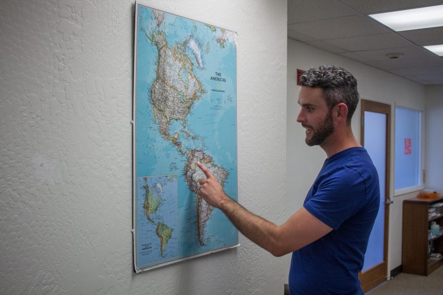 Caine Francis, director of OSU GO, points out on a map one of the destinations of the study abroad programs provided by the Office of Global Opportunities. 