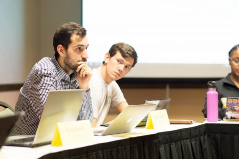 (Left) Sen. Jasen Phillips and (right) Sen. Logan Adams’ proxy discuss legislation in the Senate. ASOSU has moved up candidate information session elections to November