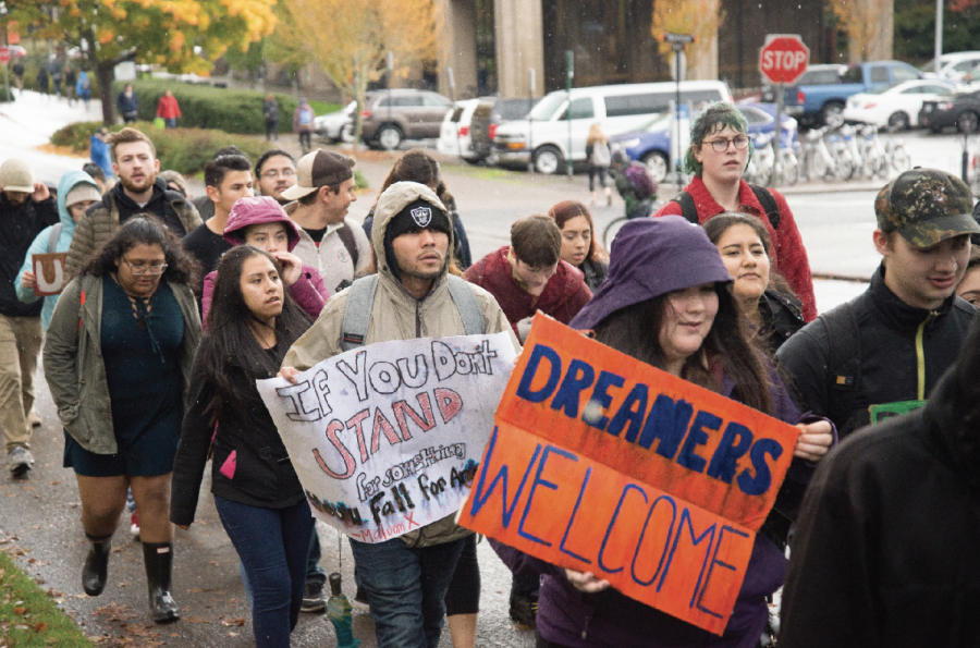 Students walk past Kerr Administration Building during a protest against the repeal of DACA Nov. 9, 2017.