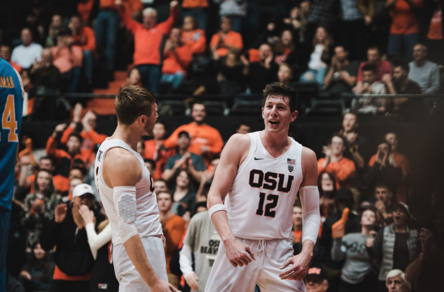 Forward Drew Eubanks and forward Tres Tinkle celebrate on the court. The team pulled off a win against UCLA.