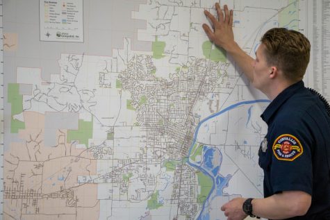 Resident volunteer and OSU student Jack Burr points at different fire stations in Corvallis on a map during a training on May 4.
