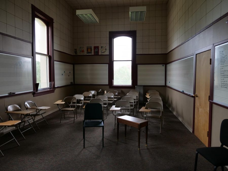 A music classroom in Benton Hall uses foldable writing chairs for students to sit in. Some who use the facility say the building was not designed for music education.