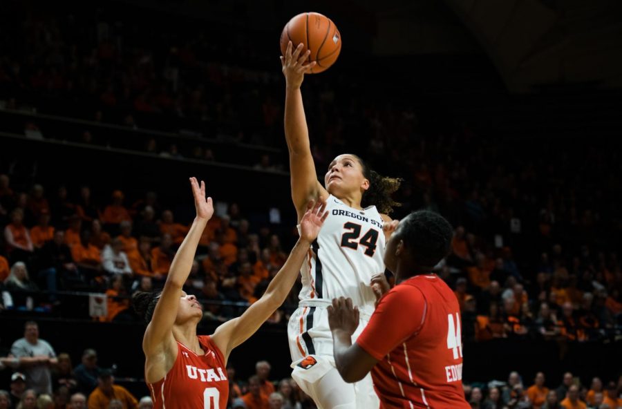 OSU sophomore guard Destiny Slocum goes high for the lay up over two Utah defenders. Slocum helped the Beavers earn the 71-63 win over the Utes by scoring 20 points, five assists and three steals on the night.