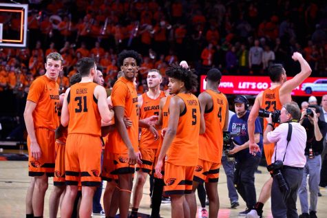 OSU freshman forward Warren Washington stands tall in the center of the team huddle after a Civil War victory at Gill Coliseum. 
