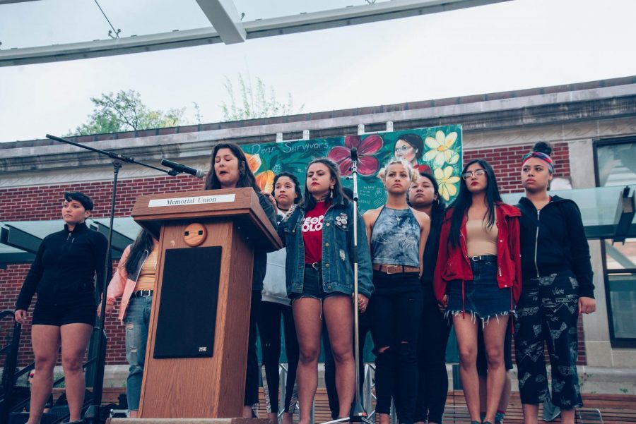 Dam Diverse Dance, known as 3D, stands on the stage at Take Back the Night 2019 in silent protest of their dis invitation to perform at the event. 
