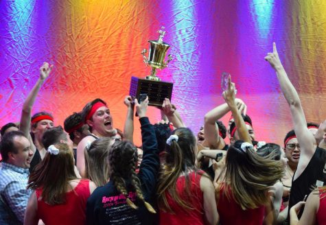 Alpha Omicron Pi and Sigma Nu hoist up their trophy after winning the 2019 All-University SING competition on May 3.