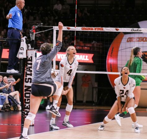 OSU Volleyball junior outside hitter Haylie Bennett (#4), senior middle blocker Serena Bruin (#24) and junior libero Grace Massey (#7) celebrate a point awarded by the referee. 