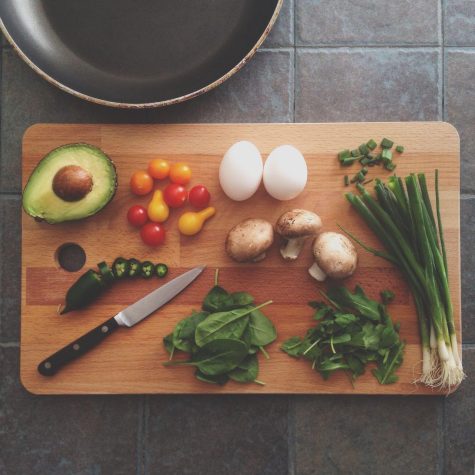 Fresh food lies spread across a cutting board. 