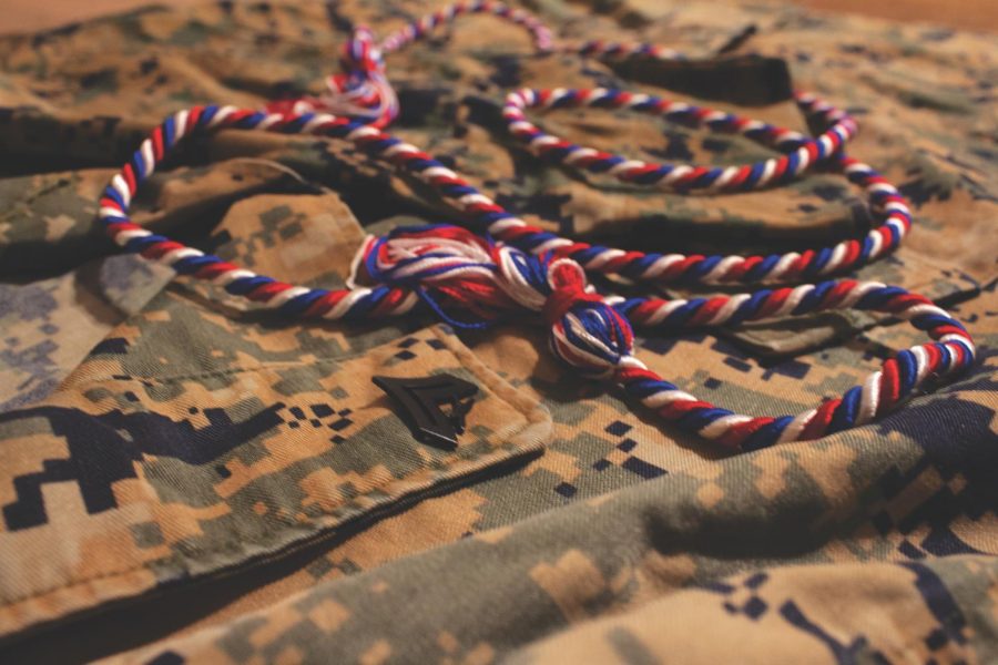 Marine Corps uniform and a veterans honor cord signify the transition from the military to college.  