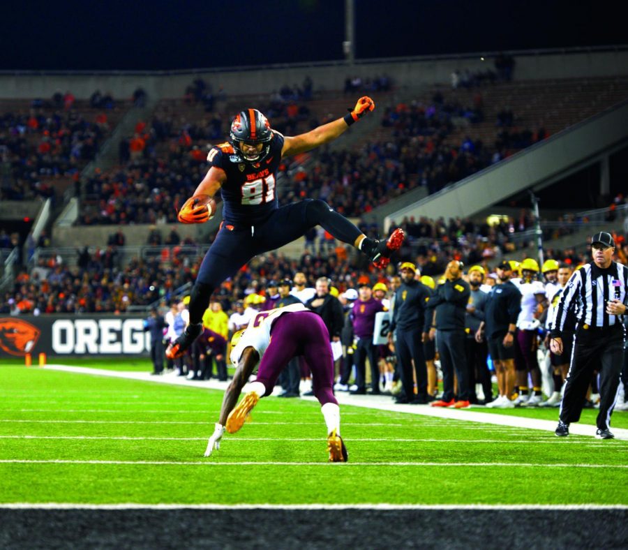 OSU redshirt senior tight end Noah Togiai (81) hurdles an Arizona State defender, a feat that resulted in a Beaver touchdown. 
