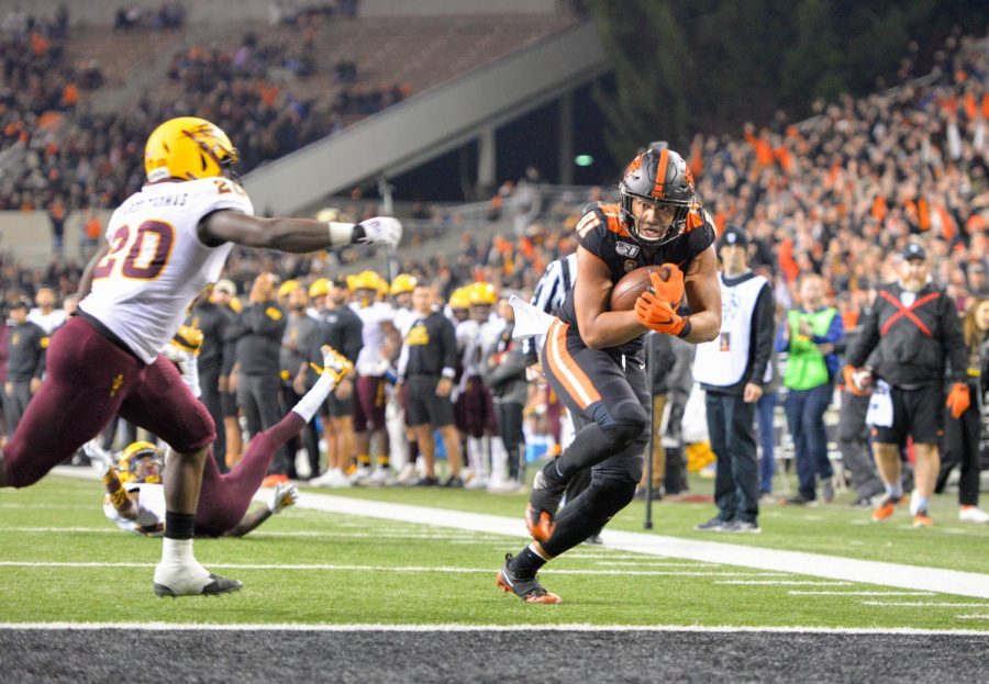 Redshirt senior tight end Noah Togiai evades a defender to reach the endzone in their matchup versus Arizona State on Nov. 16 for senior night in Reser Stadium. 