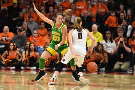 OSU senior guard Mikayla Pivec (#0) maneuvers around UO senior guard Sabrina Ionescu (#20) at Gill Coliseum. Dribbling the behind her back, Pivec advances forward to shoot two-pointer late in the third quarter, bringing OSU into the lead 39-38. 