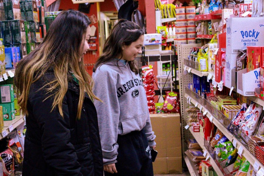 First-year students Sophie Provencio and Kate Truong shop at Bazaar International Market.