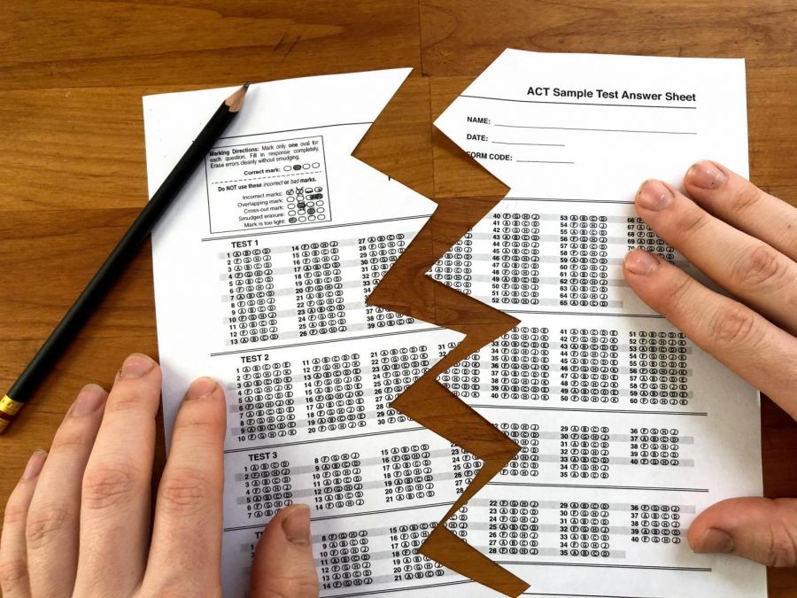Pictured is a photo illustration of a practice ACT test that is ripped down the center. President Ed Ray released a statement on March 25, notifying Oregon State University students that standardized testing scores—the ACT or SAT— would no longer be required for admission, allowing for a “test-flexible” approach.