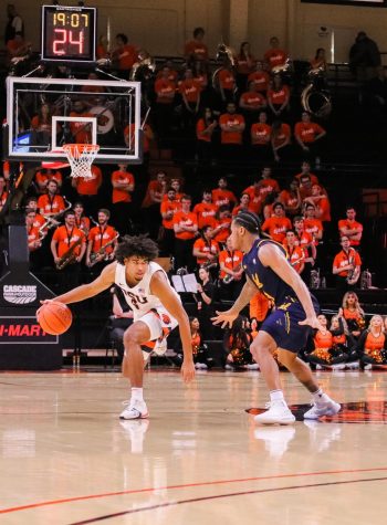 OSU junior Ethan Thompson dribbles up the court past California senior Paris Austin during the game versus California in Gill Coliseum on March 7.