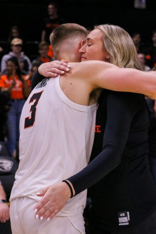 OSU senior forward Tres Tinkle hugs his sister, Joslyn, as he finishes senior night in Gill Coliseum on March 7.
