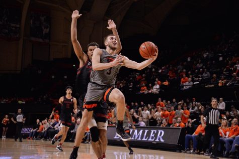 OSU senior forward Tres Tinkle goes up for a shot against a Stanford defender in Gill Coliseum on March 5. 
