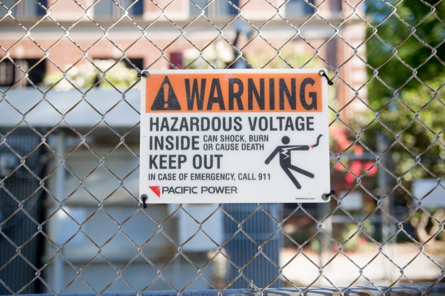 A Pacific Power warning sign hangs on a fence. Pacific Power is the company responsible for serving Oregon State University’s power needs.