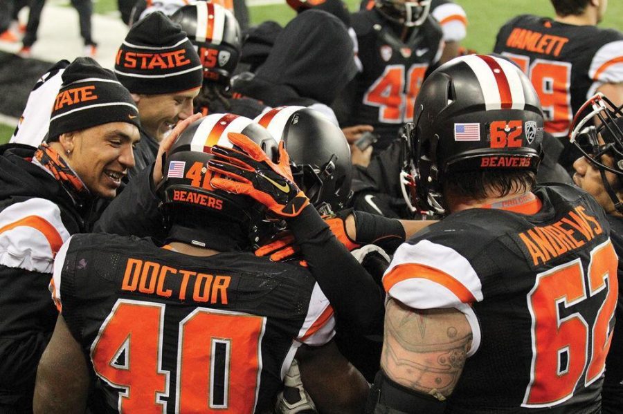 Oregon State teammates congratulate fifth-year senior linebacker Michael Doctor after his game changing pick-six against ASU at home on Nov. 15, 2014 in Reser Stadium. 