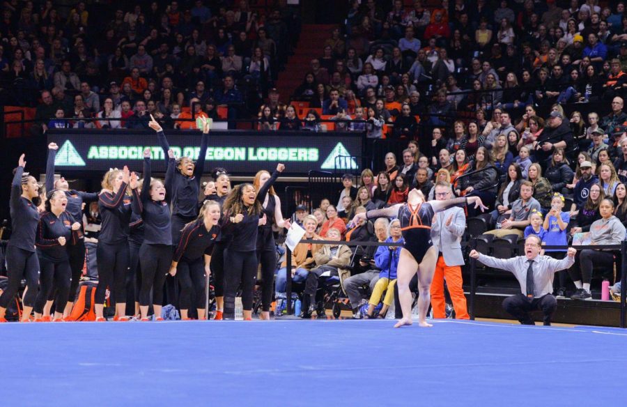 OSU sophomore Kristina Peterson performs her floor routine as the OSU gymnastics team cheers during meet versus UCLA on Feb. 29, 2020 in Gill Coliseum.