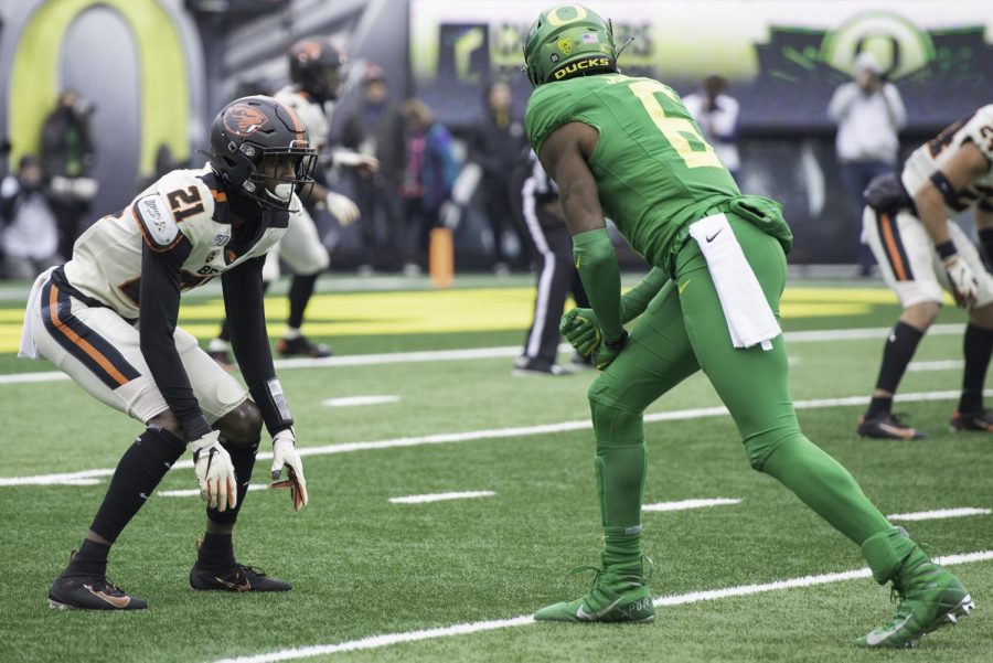 OSU senior running back Artavis Pierce (#21) lines up against UO junior cornerback Deommodore Lenoir (#6) in the Civil War on nov. 30, 2019 in Autzen Stadium. With the plan of changing the name of the rivalry, the game is expected to be the last football rivalry matchup under the Civil War moniker. 