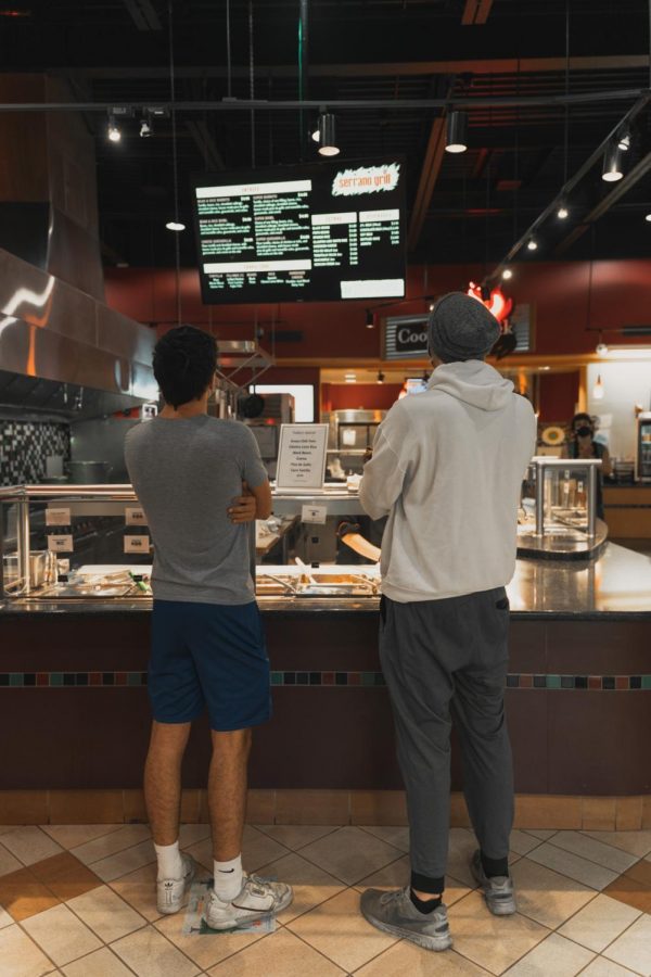 OSU freshman Noah Pragin (left), majoring in Computer Science and Sean Coleman (right), majoring in Biochemistry, ordering food at Serrano Grill. West Dining Hall is their favorite dining hall because it’s close to their resident hall and has the best food.