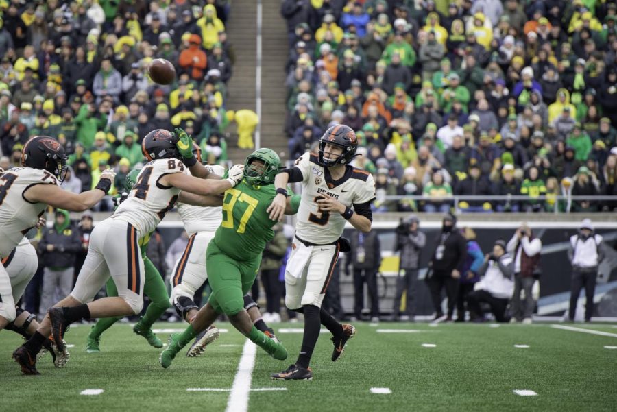 In+this+file+photo+from+2019%2C+OSU+redshirt+sophomore+quarterback+Tristan+Gebbia+%28%233%29+throws+a+pass+while+under+pressure+from+UO+freshman+defensive+tackle+Brandon+Dorlus+%28%2397%29+in+Autzen+Stadium.%C2%A0This+season%2C+Gebbia+was+able+to+get+his+revenge+in+a+41-38+win+over+the+Oregon+Ducks.
