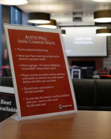 The signage in Austin Hall showing students how to socially distance while studying as a slideshow with their dos and don’ts plays in the background. Austin Hall has signs on each seat marking them as available or unavailable to show how students can socially distance.