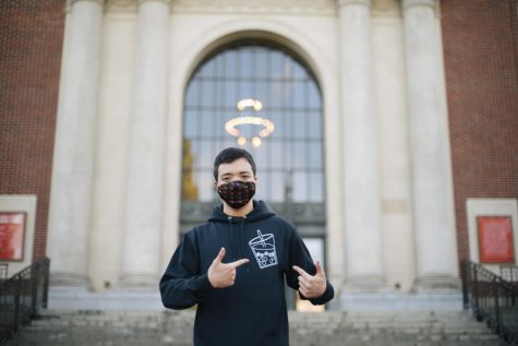 Josh Brenne, co-president of the Asian Pacific American Student Union, poses outside of the Memorial Union in his APASU hoodie and OSU mask. The APASU organization is a mean for people of similar cultural backgrounds or interests to come together socially and culturally.