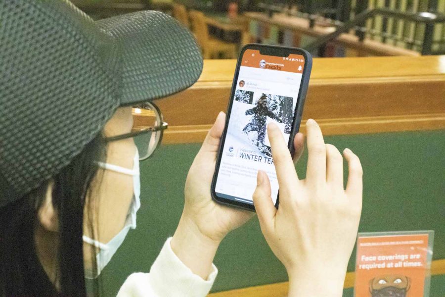 Tengjiao Wei, Sophomore of digital communication is checking out the updates of winter term through the new app that OSU Cascades has been pushing around campus.