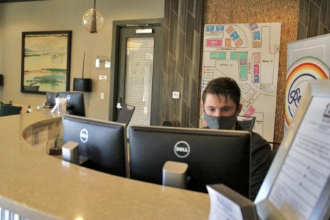 A staff member at The Retreat at Corvallis working in the main office of the housing complex. The Retreat is one of several student-apartment complexes close to the OSU campus.