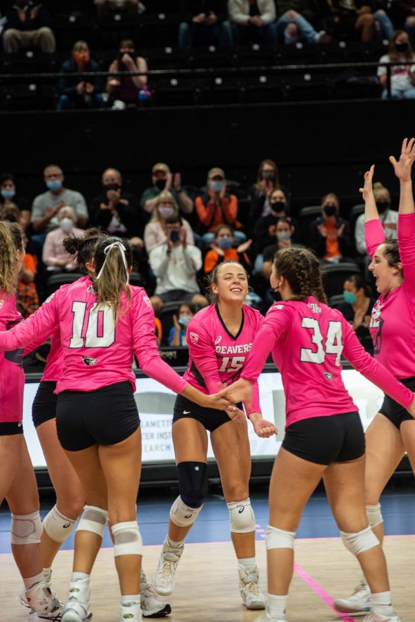 The OSU volleyball team celebrates after scoring a point in the game versus the Washington State Cougars on Oct. 15. The Beavers would go on to lose the game, 0-3. 