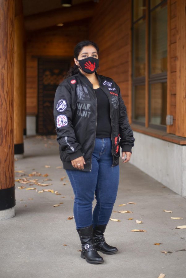 Center Director Kaku-Ixt Mana Ina Haws and Assistant Professor, School of Language, Culture, and Society Luhui Whitebear poses in a mask acknowledging Missing and Murdered Indigenous Women. The image of a red handprint has come to symbolize the MMIW movement as a way to represent the thousands of women who have been silenced. 