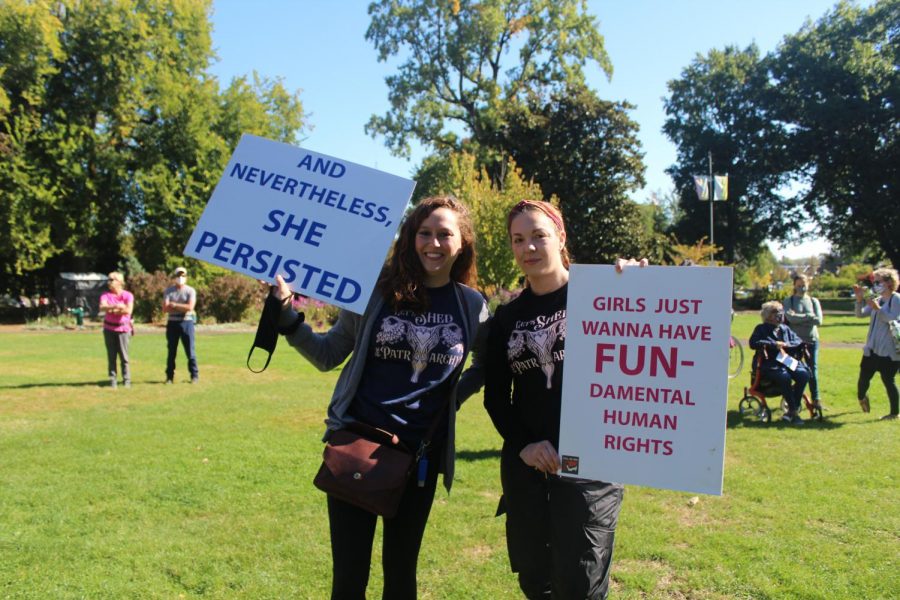 Rebecca Freeby and Grae Addams hold up signs protesting Texas’s Senate Bill 8 at Central Park in Corvallis, Ore. on Oct. 2. SB8 restricts most abortions in the state of Texas after six weeks of pregnancy.