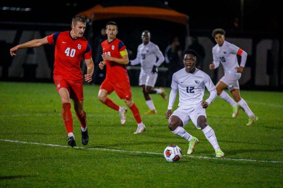 Oregon State sophomore midfielder Mouhameth Thiam driving the ball up the pitch at Paul Lorenz Field on Nov. 21. Thiam finished the game with 1 goal for the Beavers, helping them with against the St. Johns University Red Storm by a score of 2-0.